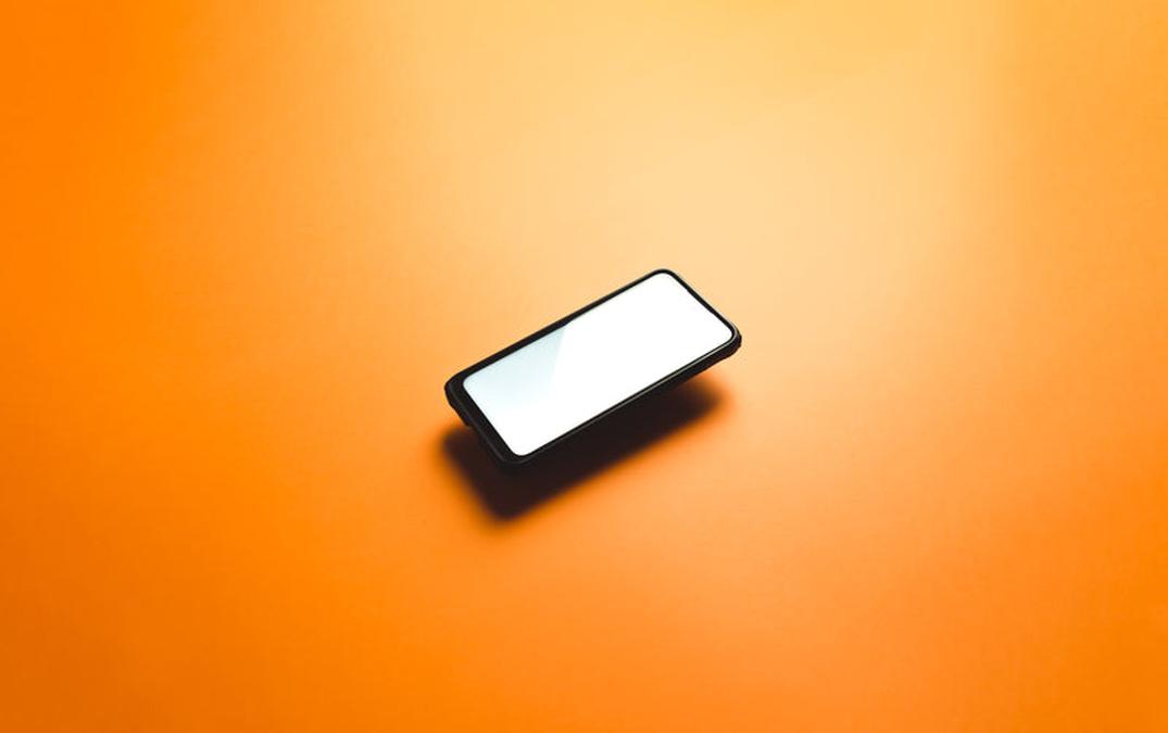 a cellphone floats in the middle of orange background - Image of Productivity, "RescueTime app"