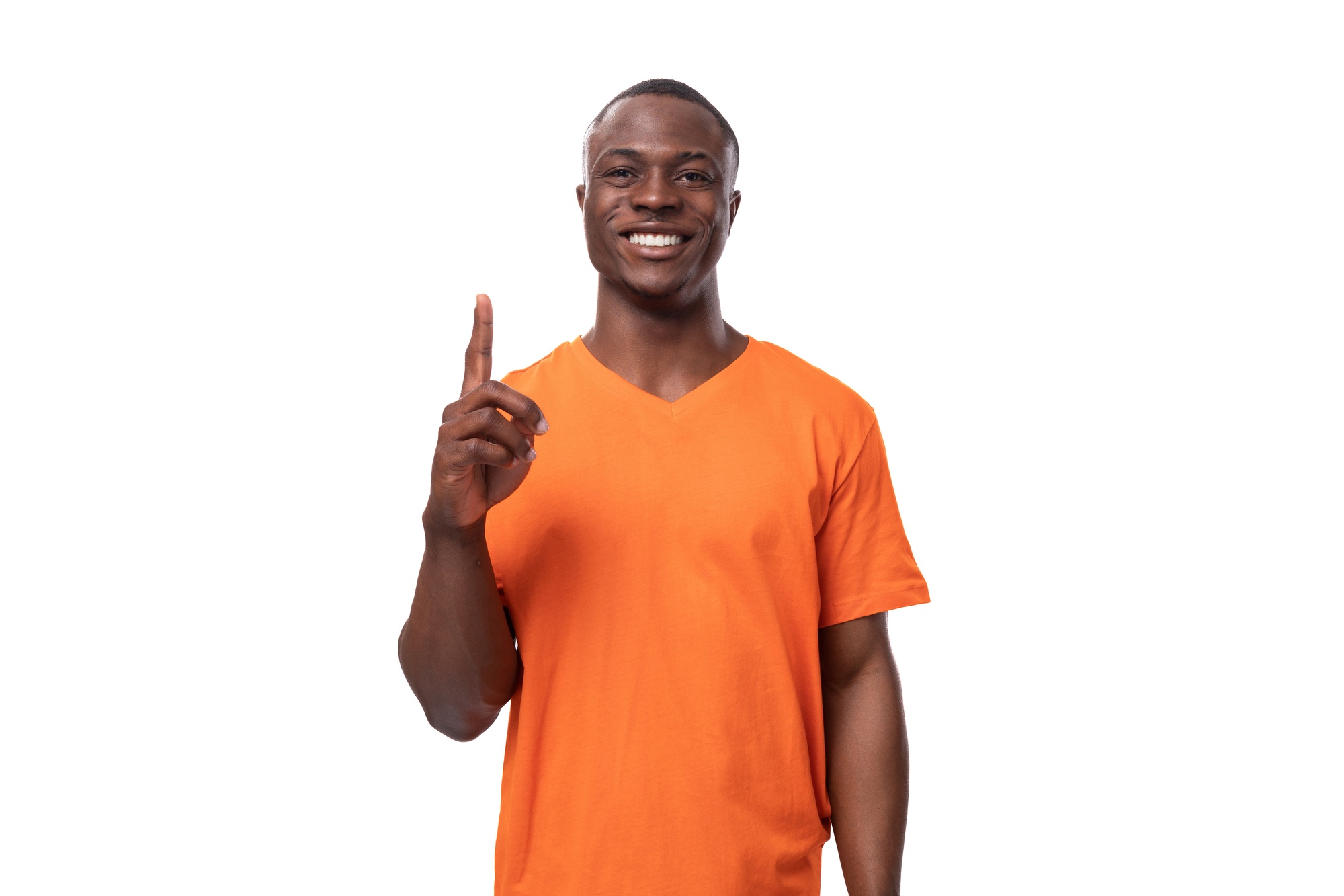 young positive happy american man in orange t-shirt points his finger at the presence of interesting